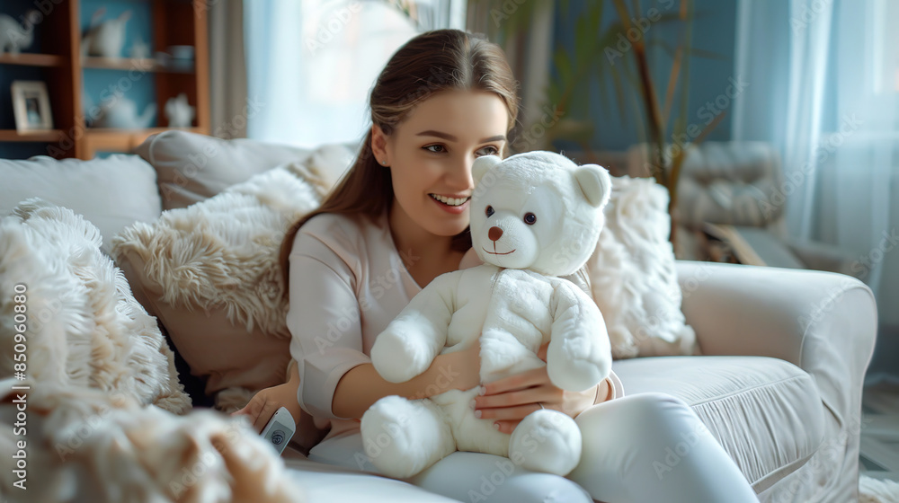 A girl plays with a white soft toy bear. Mom dressed her baby in a polar bear costume. A girl plays with a white soft toy bear. Mom dressed her baby in a polar bear costume.