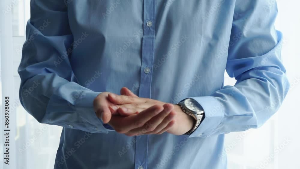 a man in a blue shirt claps his hands.
Man applauding in the office a man in a blue shirt claps his hands.
Man applauding in the office