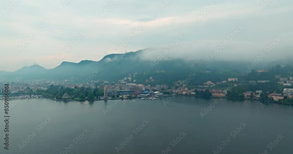 Aerial view of the landscape of Lake Como in Italy. Clouds in the mountains, rain, bad weather in the tourist town of the Alps. High quality 4k footage Aerial view of the landscape of Lake Como in Italy. Clouds in the mountains, rain, bad weather in the tourist town of the Alps. High quality 4k footage