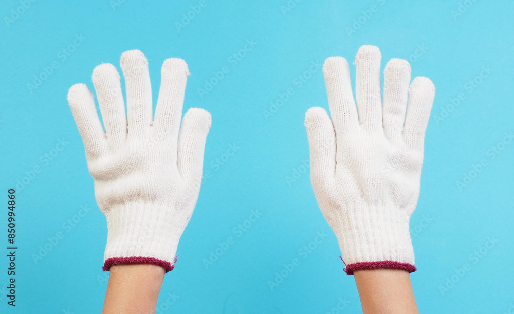 Hands is wear glove knitting on blue background. Hands is wear glove knitting on blue background.