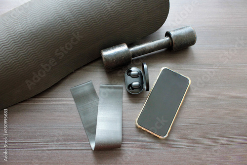 accessories for sports: mat, elastic band, dumbbell, phone, headphones