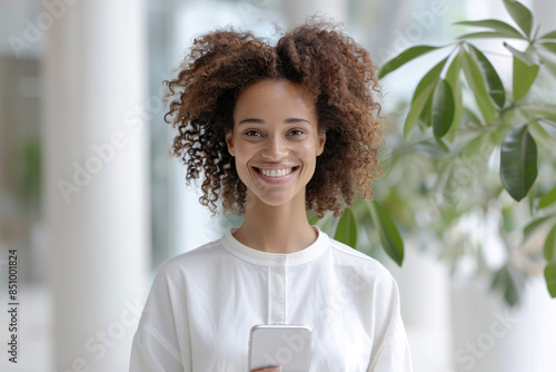 Smiling businesswoman using smartphone in office photo