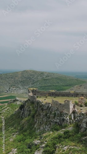 Drone footage capturing the majestic ruins of Anavarza Castle perched atop a towering mountain in Adana, Turkey photo