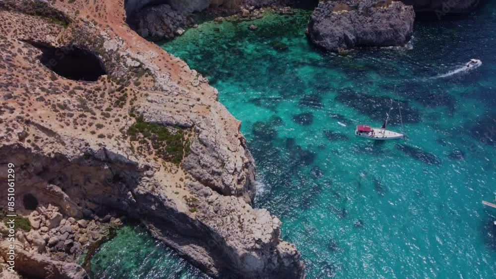 L-Ghar ta Bla Saqaf or The roofles Cave on Comino island Malta, Aerial View. Pebble cove. High quality 4k footage L-Ghar ta Bla Saqaf or The roofles Cave on Comino island Malta, Aerial View. Pebble cove. High quality 4k footage