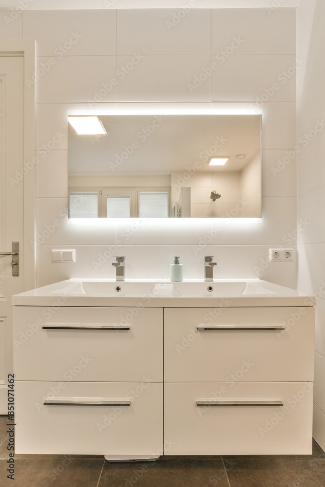A white bathroom with a sink and a mirror