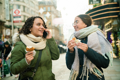 Women enjoying snacks and conversation in London photo