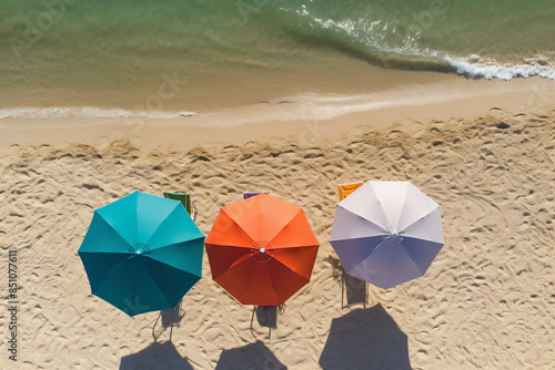 Colorful beach umbrellas on sandy shore near ocean waves