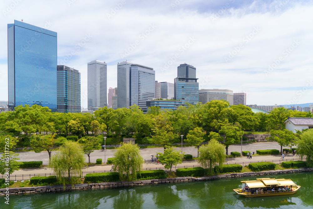 Naklejka premium Urban Oasis River and Osaka Cityscape