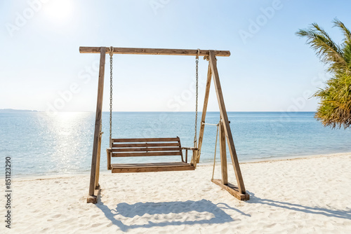 Wooden swing on a tropical beach