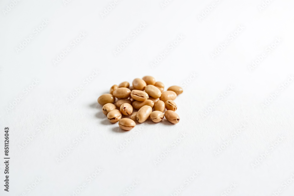 Close-up of a Pile of Light Brown Beans on a White Background Close-up of a Pile of Light Brown Beans on a White Background