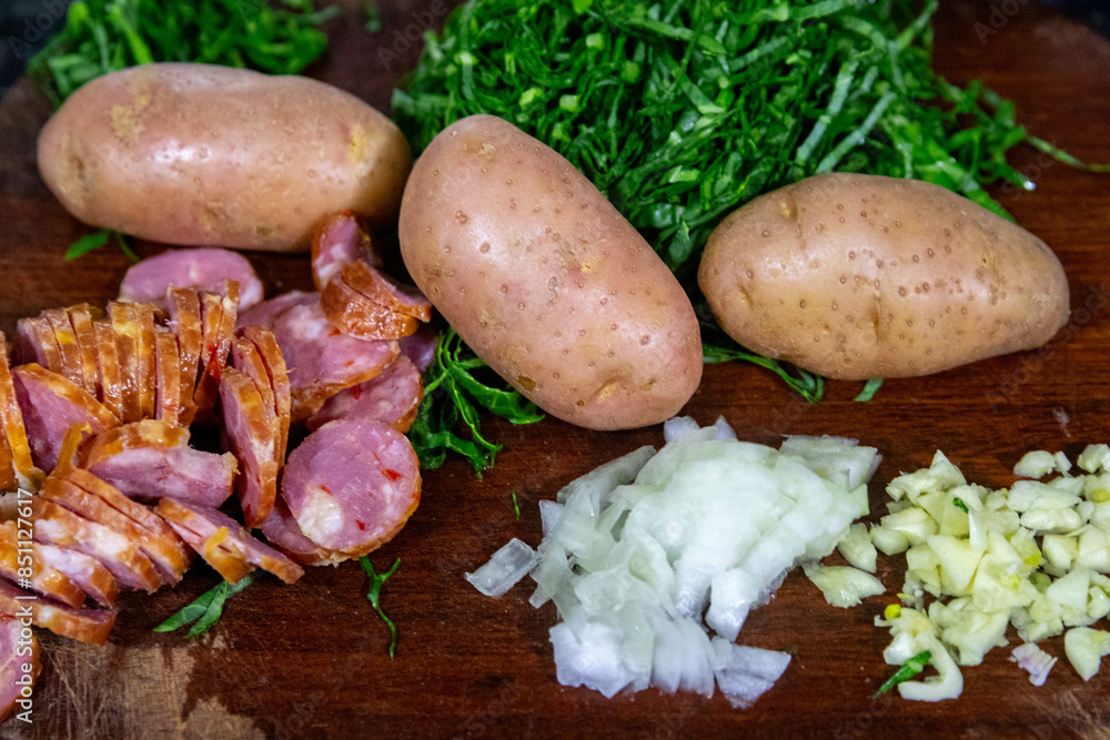 Traditional Portuguese green broth with potatoes, cabbage and chorizo sausage ingredients Traditional Portuguese green broth with potatoes, cabbage and chorizo sausage ingredients