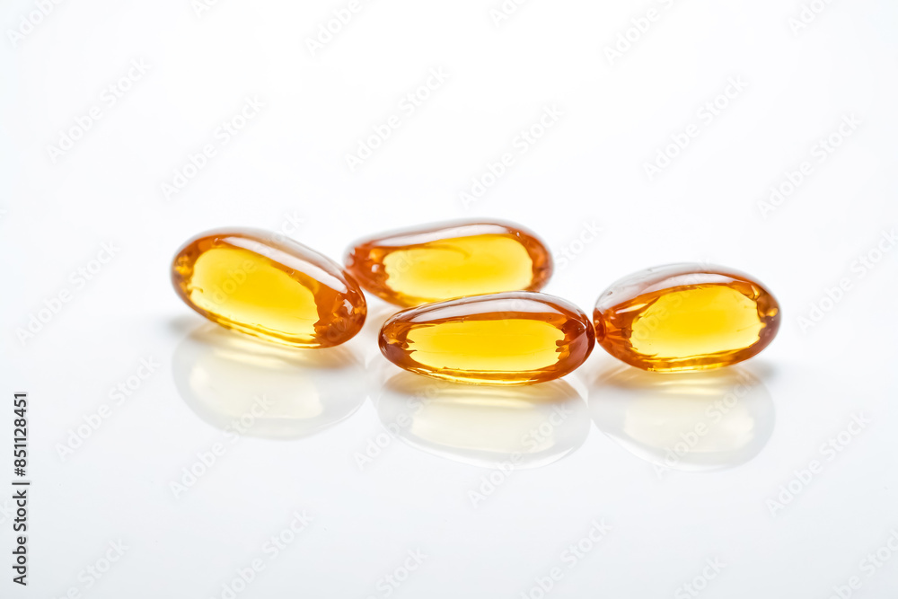 Close up of Four Yellow Oil Capsules Close up of Four Yellow Oil Capsules