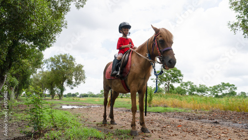 Wallpaper Mural Portrait of Asia boy riding horse in the farm Torontodigital.ca