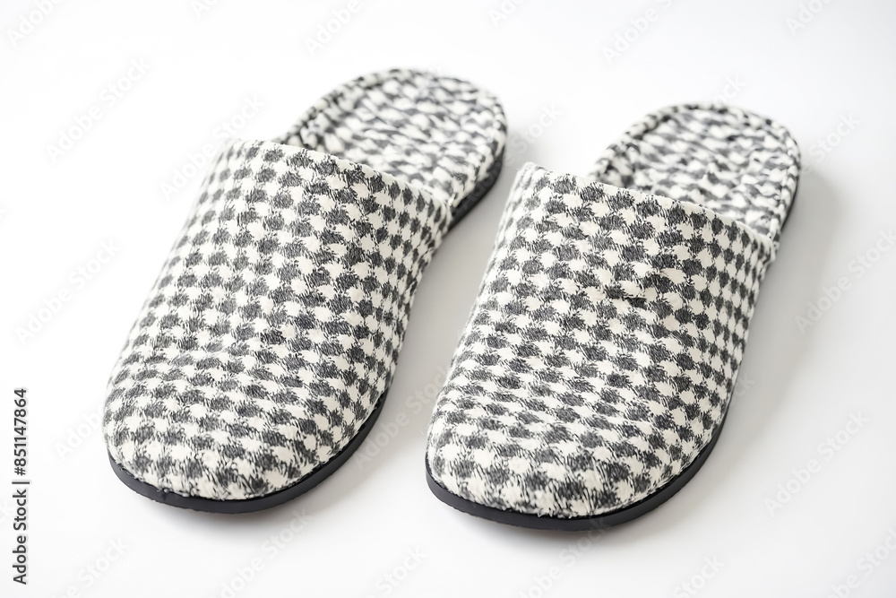 Pair of white and black checkered slippers on white background Pair of white and black checkered slippers on white background