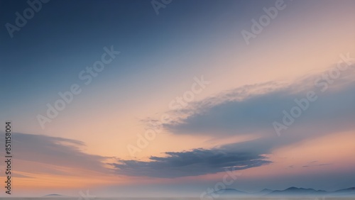 Tranquil Sunset Over Misty Mountains - A serene sunset paints the sky in shades of pink, orange, and blue over a range of mist-covered mountains.