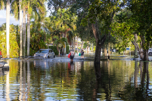 These images show the 2024 Hallandale Beach flood aftermath. Residential streets and cars are submerged, reflecting the severe impact of flooding on communities and highlighting the need for recovery 