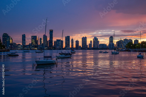 city skyline with boats at sunset