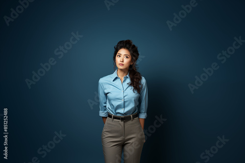 Portrait of a woman wearing a blue outfit on an isolated background with copy space