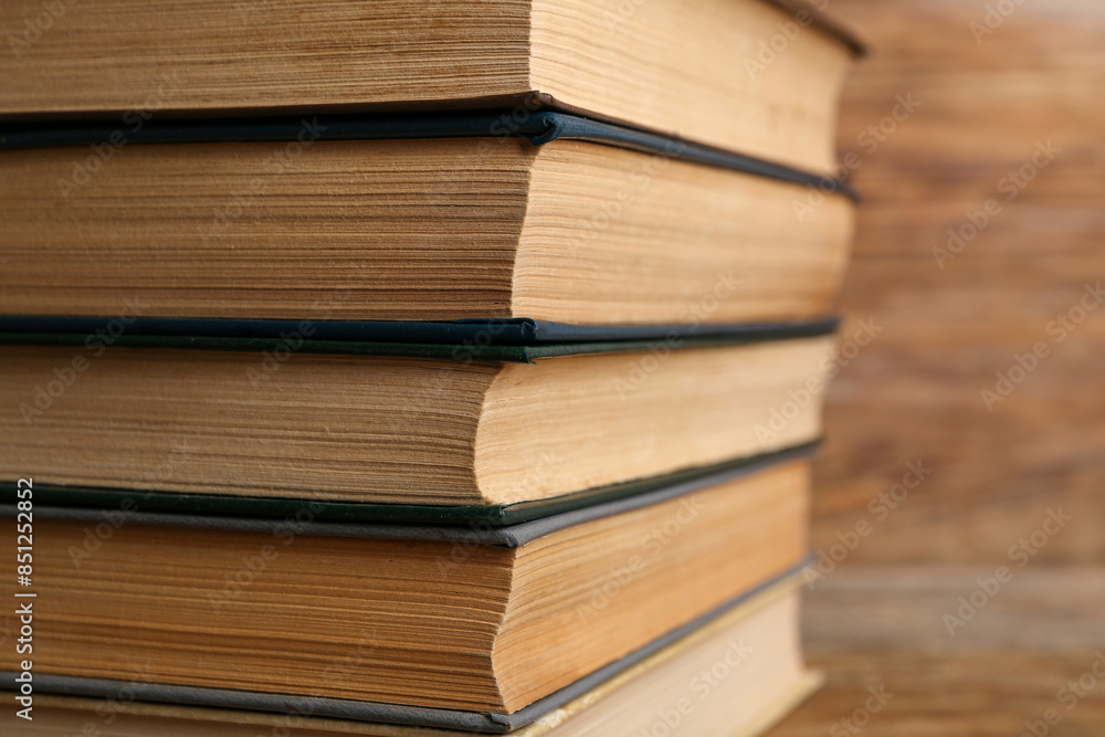Stack of old hardcover books on wooden background, closeup Stack of old hardcover books on wooden background, closeup