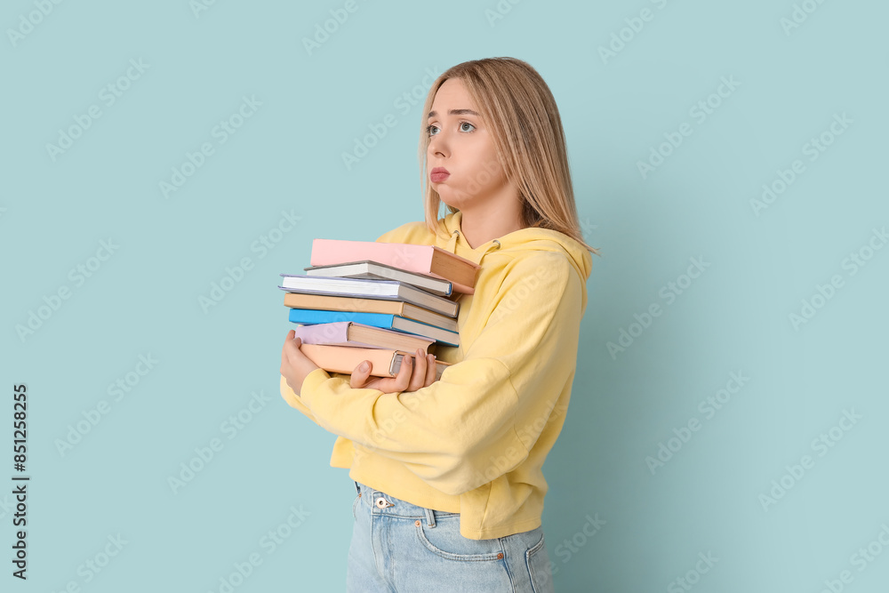 Beautiful young woman with many books on blue background Beautiful young woman with many books on blue background