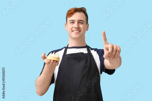 Male confectioner in apron ...