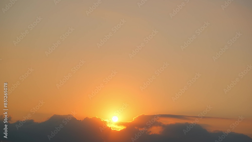 A serene sunrise with the sun emerging from behind dark clouds, casting a brilliant golden light across the sky. The scene is tranquil, with a soft gradient from orange to pale blue above.
A serene sunrise with the sun emerging from behind dark clouds, casting a brilliant golden light across the sky. The scene is tranquil, with a soft gradient from orange to pale blue above.