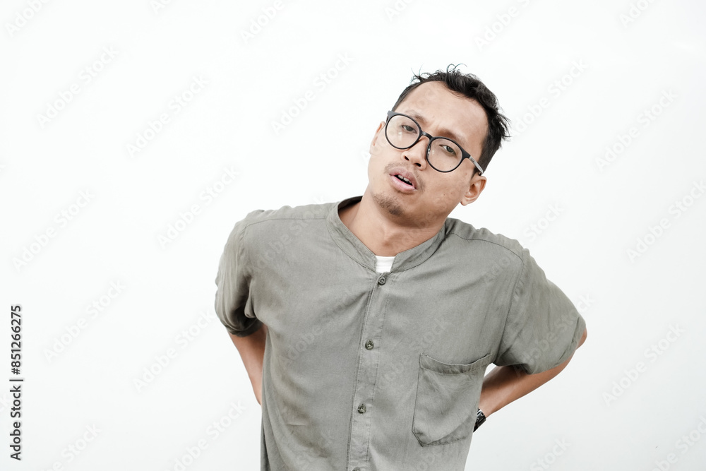 a young man wearing a plain shirt and wearing glasses with back pain. With a plain white background a young man wearing a plain shirt and wearing glasses with back pain. With a plain white background