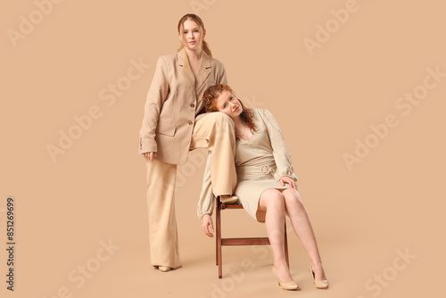 Stylish redhead sisters sit...