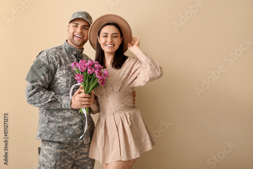 Man in military uniform hug...