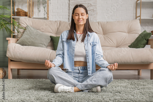 Young woman meditating on f...