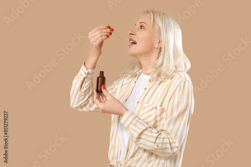 Mature woman taking CBD oil...