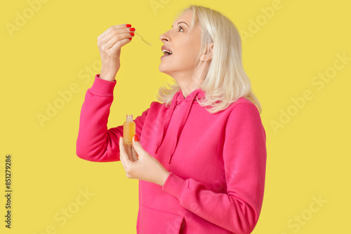 Mature woman taking CBD oil...
