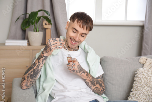 Young tattooed man with bot...