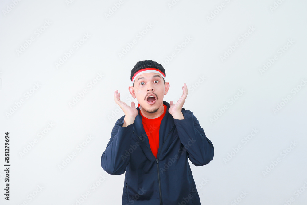 Shocked young Asian man in casual t-shirt isolated on white background. indonesian independence day celebration concept Shocked young Asian man in casual t-shirt isolated on white background. indonesian independence day celebration concept