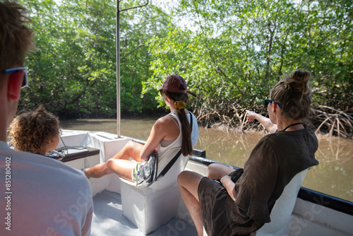 Cuadro en lienzo View from behind of a Family on a wildlife estuary boat tour in Costa Rica