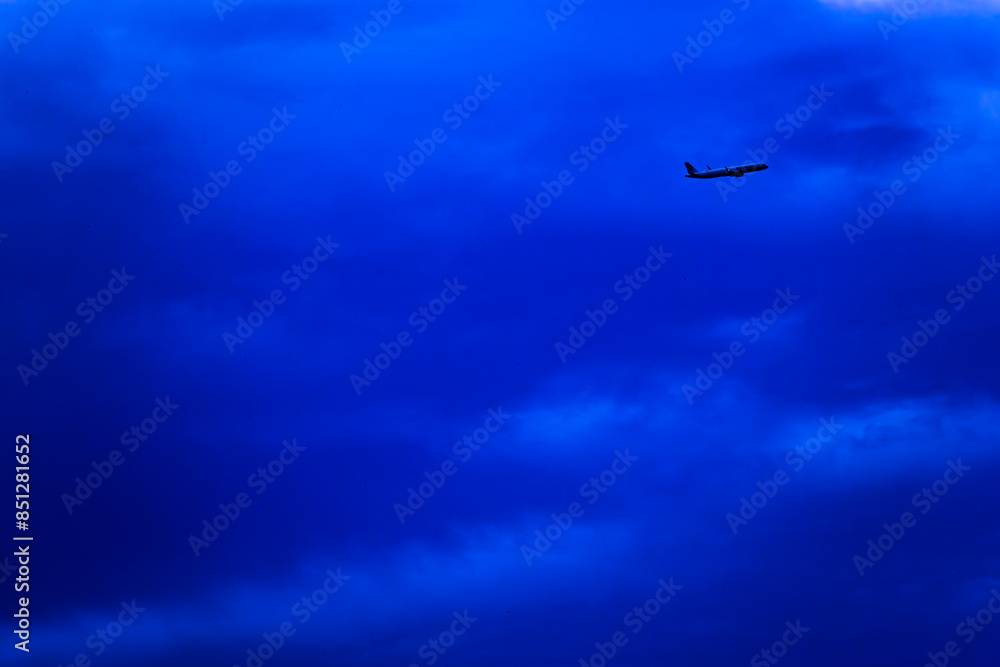 A blue sky with a plane flying through it A blue sky with a plane flying through it