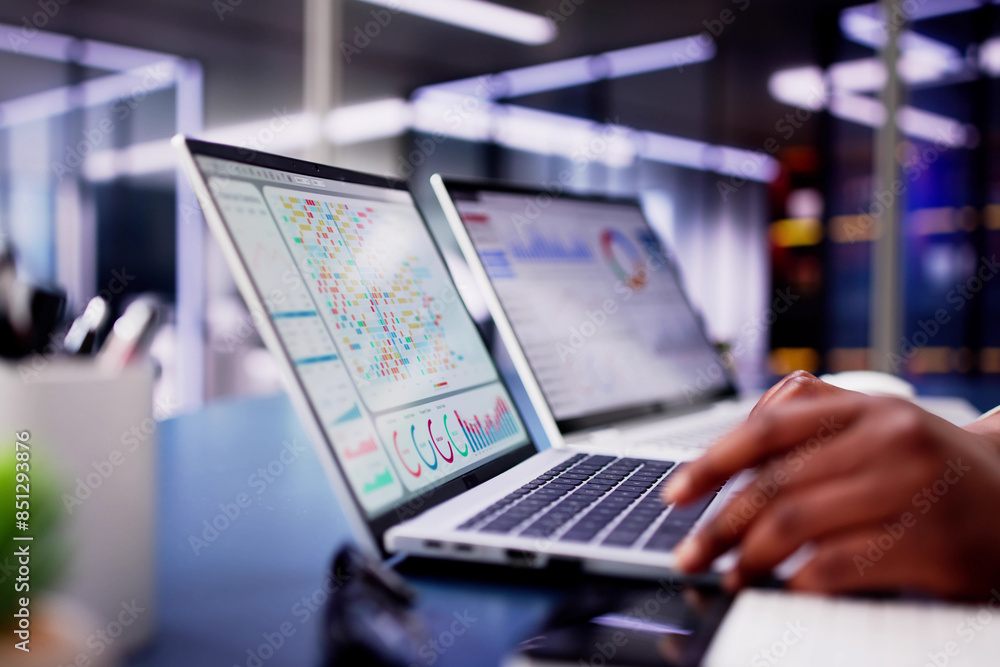 African American woman using virtual dashboard to predict emerging market trends African American woman using virtual dashboard to predict emerging market trends