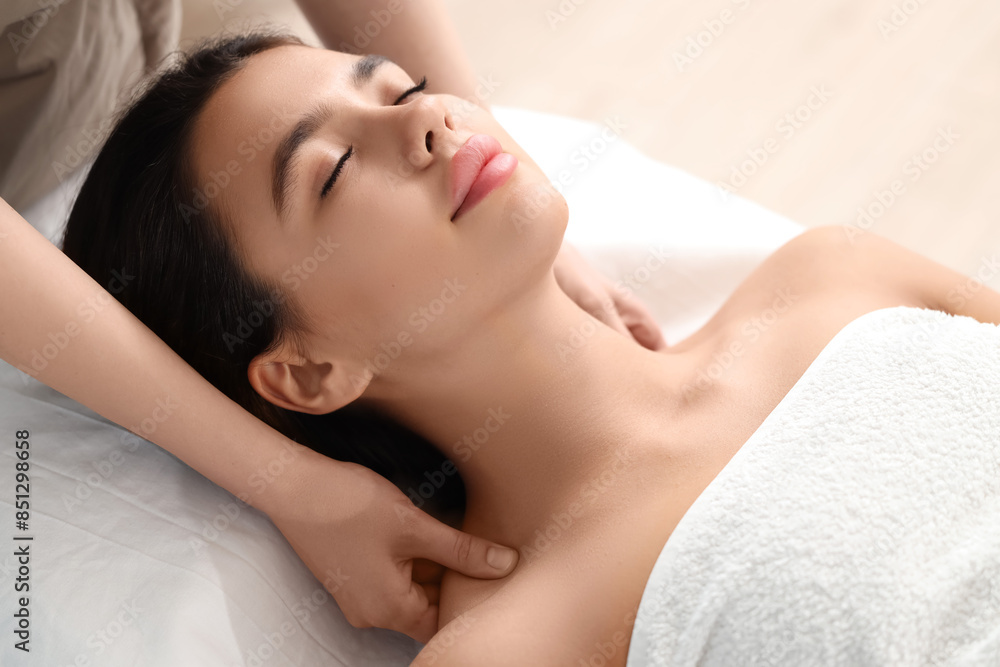 Young woman getting facial massage in salon, closeup Young woman getting facial massage in salon, closeup