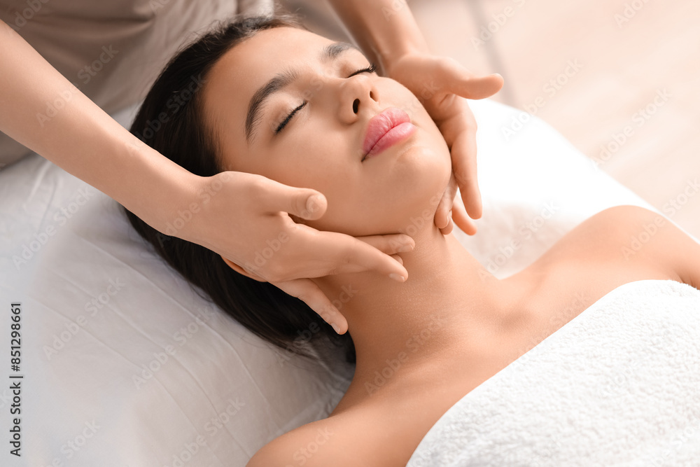 Young woman getting facial massage in salon, closeup Young woman getting facial massage in salon, closeup