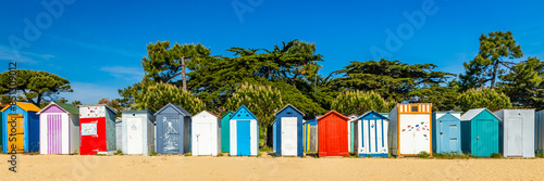 Fototapeta Multi-colored huts of the beach of La Boirie on the Oleron island in Saint-Denis