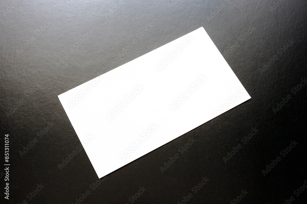 White business card on a black background. White business card on a black background.