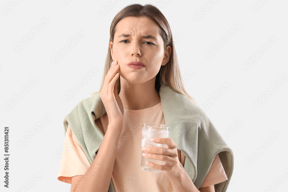 Young woman with glass of cold water suffering from tooth ache on white background Young woman with glass of cold water suffering from tooth ache on white background