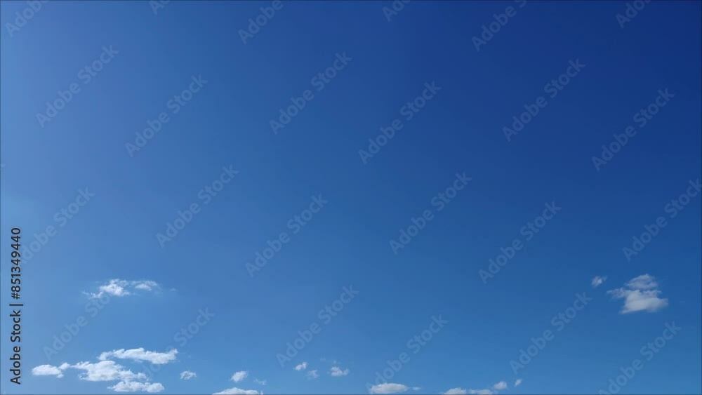Almost clear sky with some bright clouds moving across the sky in the afternoon Almost clear sky with some bright clouds moving across the sky in the afternoon