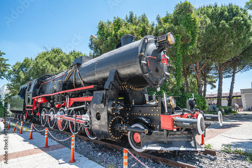Foto Steam locomotive in very bad condition, completely rusty and abandoned on the unused tracks at Uşak Rail way station