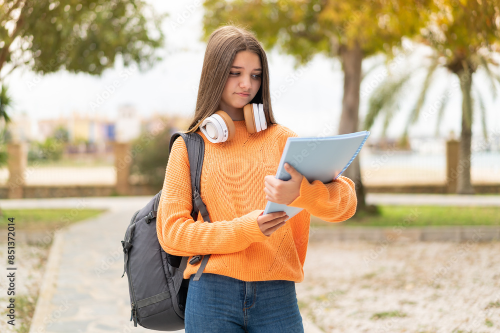 Obraz premium Young student girl over isolated background with sad expression