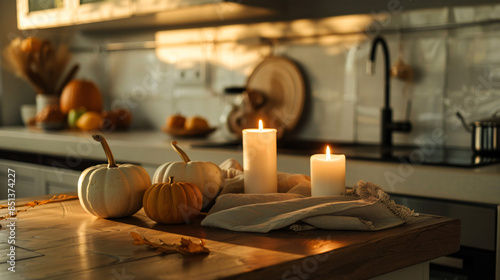 Fresh pumpkins with burning candles and napkin on coun