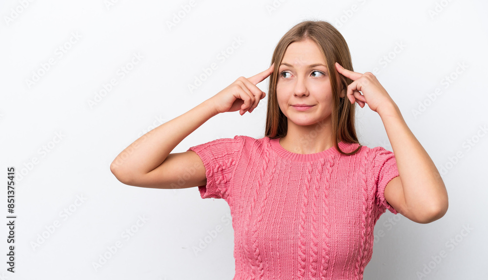Young Russian woman isolated on white background having doubts and thinking Young Russian woman isolated on white background having doubts and thinking