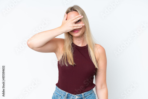 Young caucasian woman isolated on white background covering eyes by hands and smiling © luismolinero