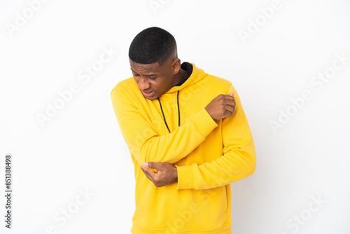 Young latin man isolated on white background with pain in elbow