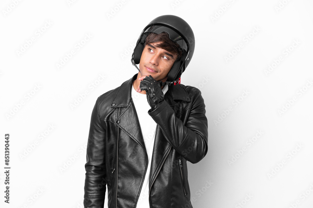 Young man with a motorcycle helmet isolated on white background and looking up Young man with a motorcycle helmet isolated on white background and looking up